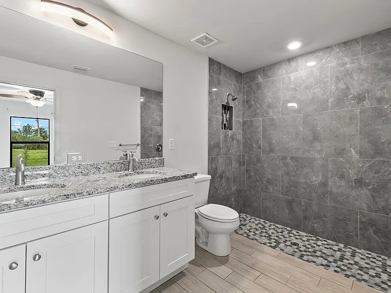 Fulled tiled modern master bath with double vanity