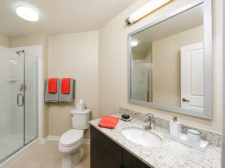 Classic Package II townhome bath with white speckled granite countertop and espresso cabinetry