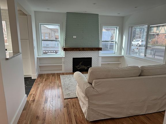 Living room with gas fireplace, oak hardwood floors, builtins.
