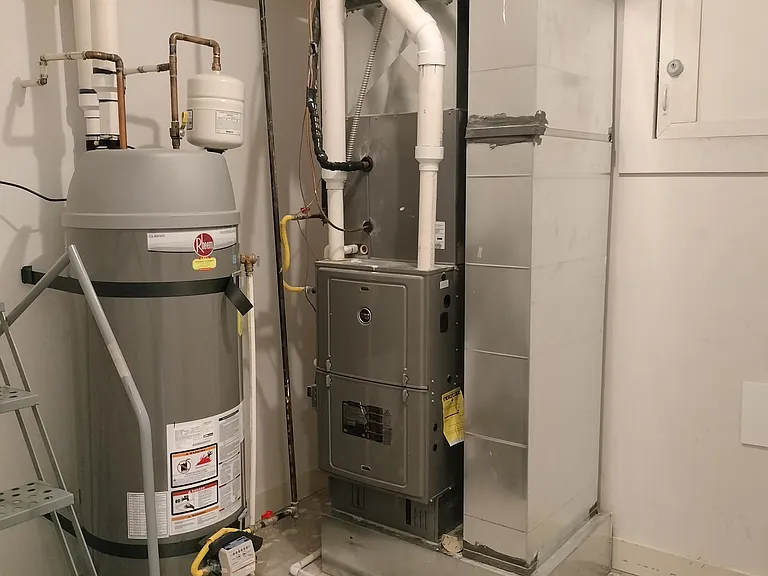 The utility room is thoughtfully designed with efficiency and cost savings in mind. It features a high-efficiency green water heater and furnace, ensuring lower energy consumption and reduced utility costs for tenants.