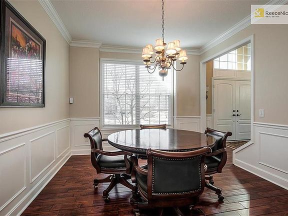 Large Formal Dining Room with wainscoting & gleaming hardwood floors.