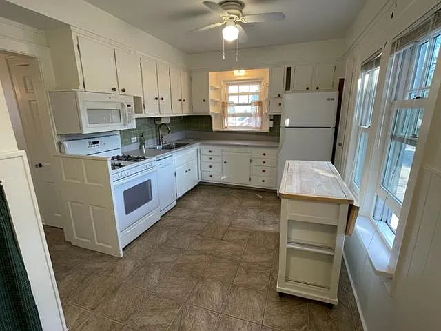 Full-size kitchen including range, over-range microwave/exhaust hood, dishwasher, sink with disposal and refrigerator freezer with ice maker. Island cabinet with drop-down breakfast island is also included. Lots of natural light and storage, too!