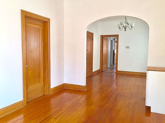 classic oak beauty that you will not see in new construction . the arch lends a special elegance. The entrance door from hall opens into the living room, and beyond the arch the dining rm. or office, with swinging door to the art deco kitchen. chande