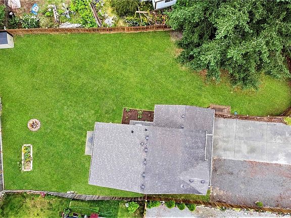 Over head view of property showing off the huge grass covered and fenced back & side yard. 