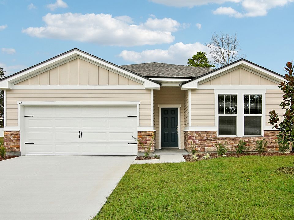 Elegant stone facade and sleek design define this Palm Coast residence, offering modern luxury and c