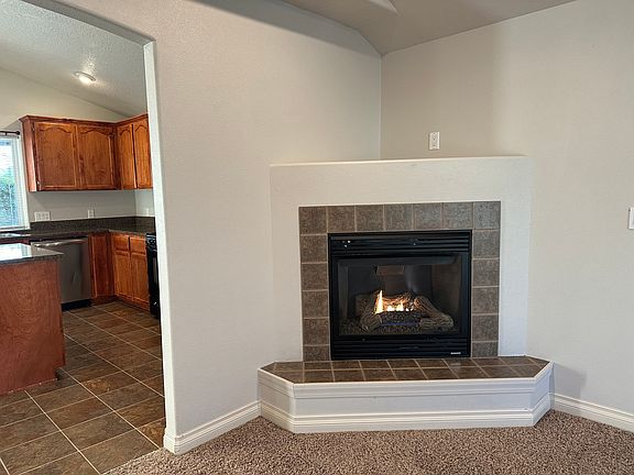 family/living room with gas fireplace leading to kitchen