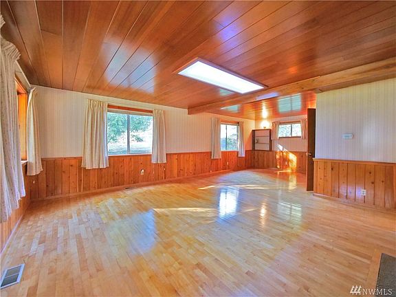 Real, quality hardwood floors, and wood ceiling. Love the cabin look or give it a light refresh to modernize the space. 