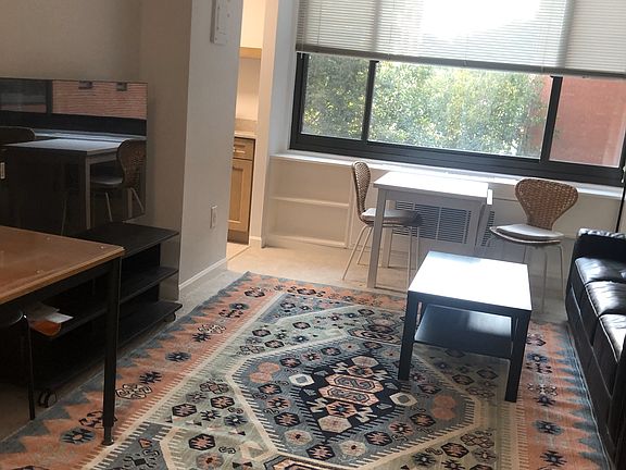 Living area: large 55" TV to left and edge of desk/workstation.
