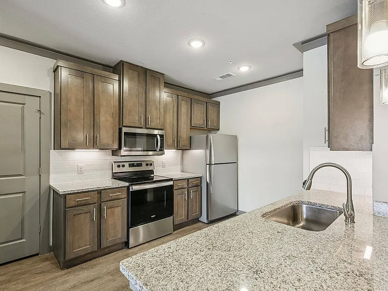 The kitchens at Cityscape Apartments include granite countertops, modern cabinetry, and open layouts.