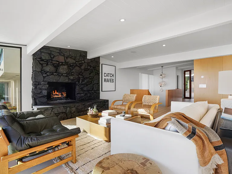 Stretch out on plush seating, framed by coastal textures and modern design.