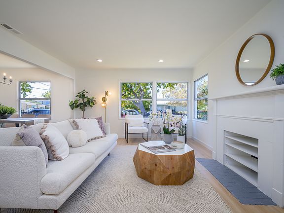 Bright open living space with light oak luxury vinyl plank flooring, fresh paint, recessed lighting, and abundant natural light.
