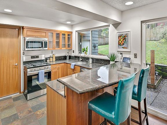 Stainless steel appliances, granite countertops, and wine fridge.