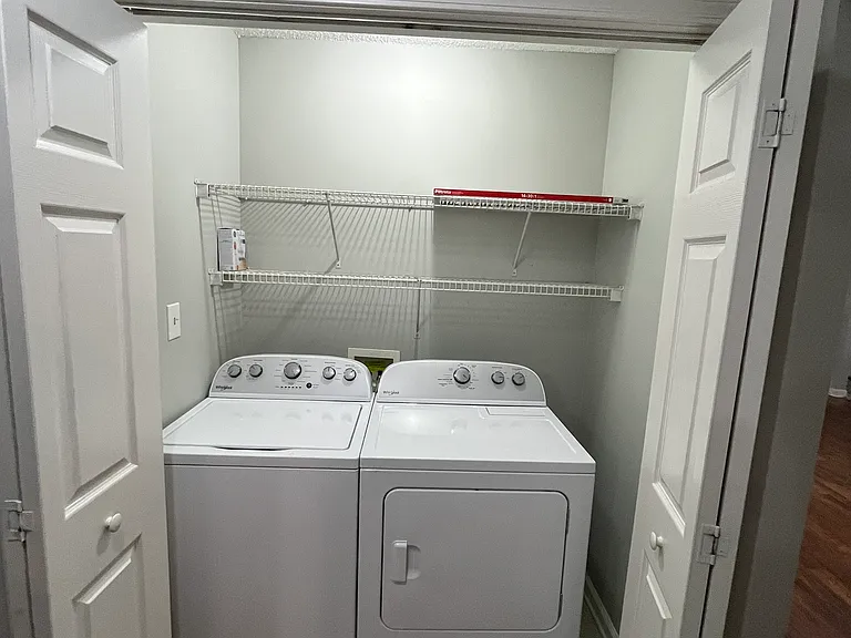 Laundry clpset with washer and dryer.