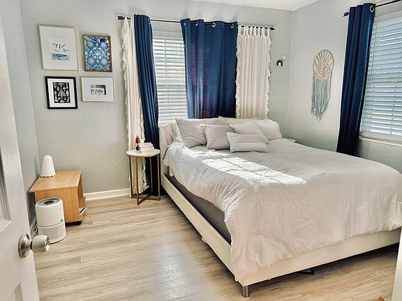 Master bedroom with attached bath and mirrored closets