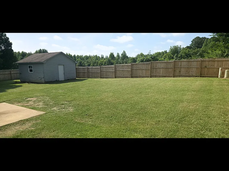 Back yard with shed. Fenced in