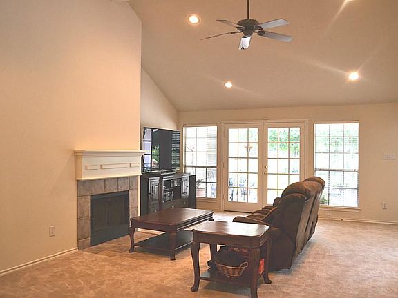 Soaring ceiling in the great room will recessed lighting and french doors flanked by floor to ceiling windows.