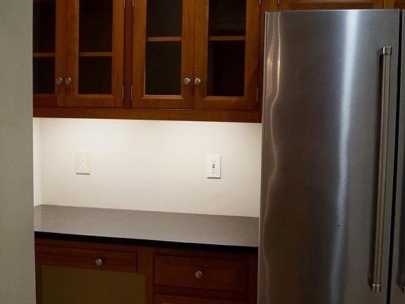 Kitchen refrigerator and desk area.