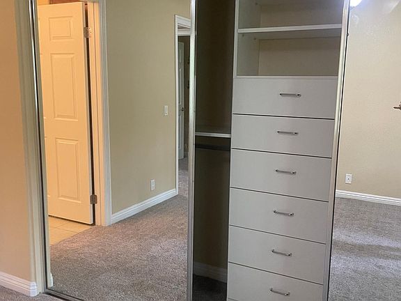 Master closet with built in dresser and shelving