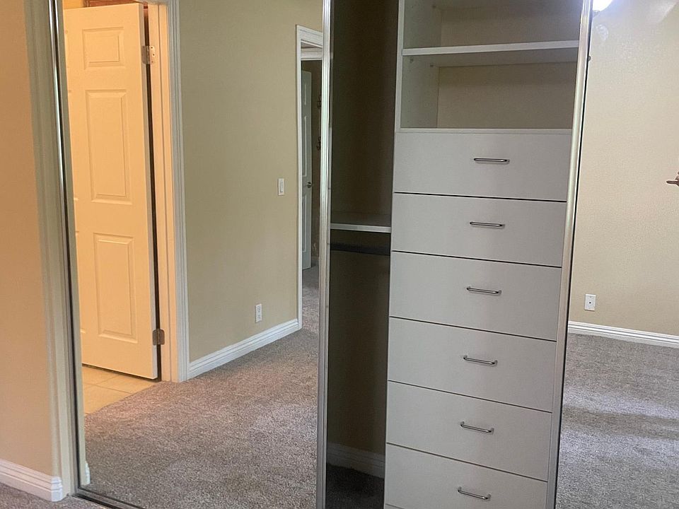 Master closet with built in dresser and shelving