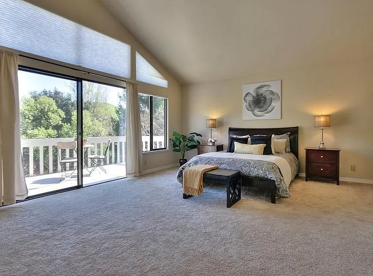 Primary Bedroom Retreat with Vaulted Ceilings and Sliding Glass Doors to Your Own Private Balcony