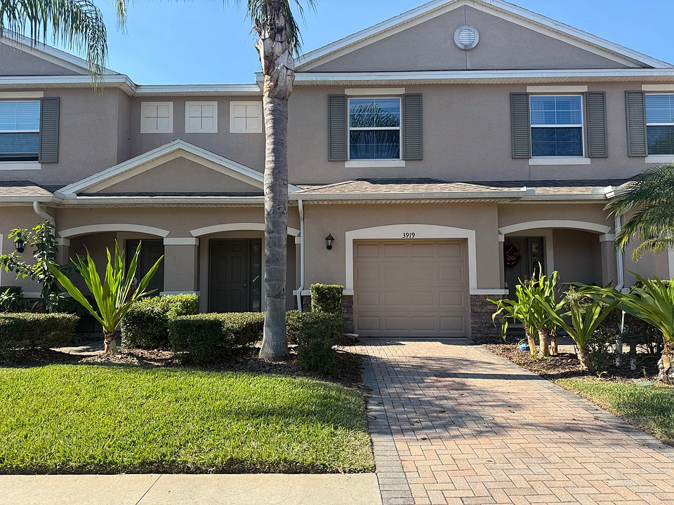 Beautiful exterior view of the front of the townhouse with a single car garage and driveway