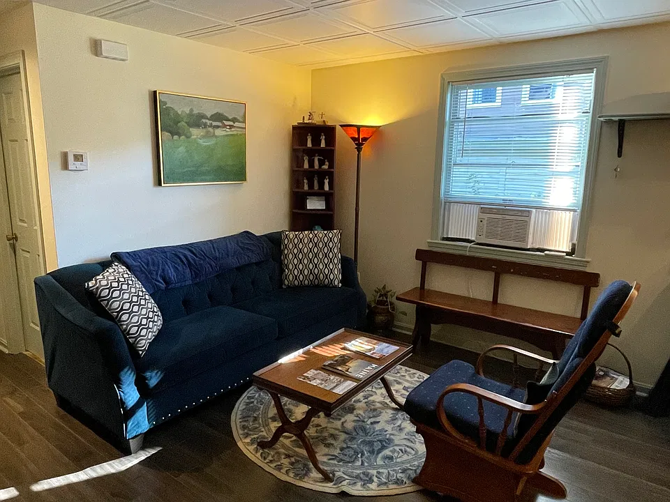 Livingroom atea with full comfy couch and great glider rocker.