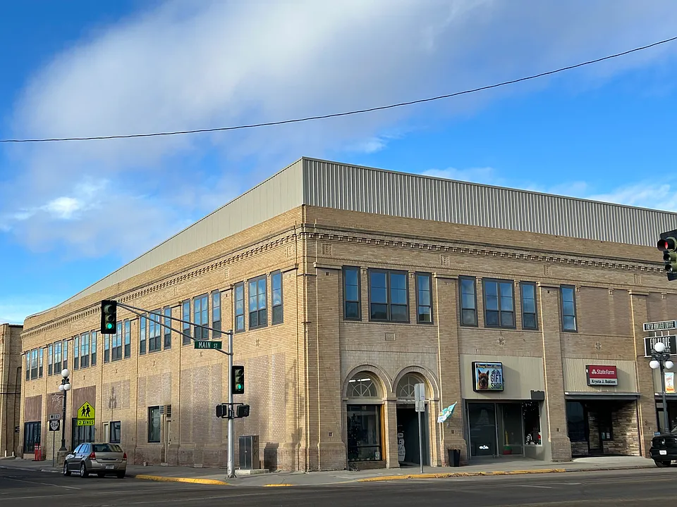 The iconic, historic, and restored building on the corner of Main Street and 4th Avenue -- housing the apartment in the second floor, with two access entrances, and several retail business at street level.