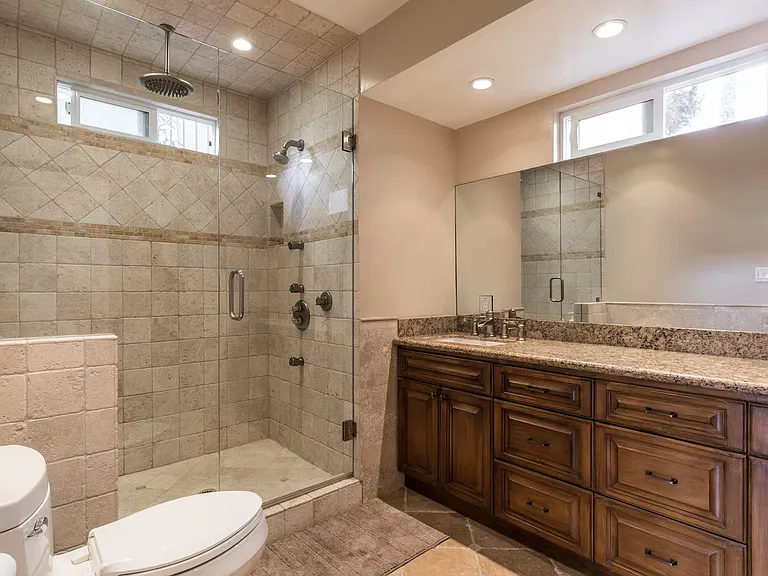 Downstairs bathroom with walk in shower and dual sinks.