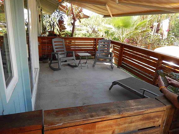Front lanai with automatic cover and wood fence enclosure