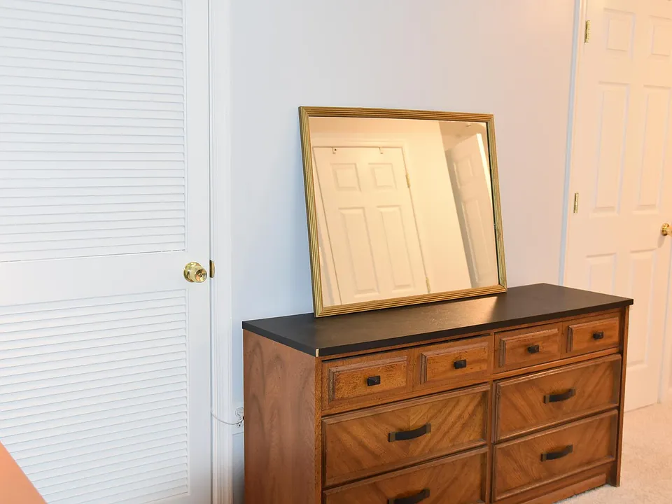 Dresser and mirror in bedroom area.