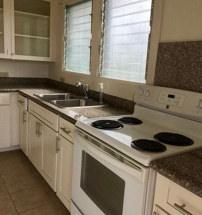 Kitchen with double sink and stove and oven