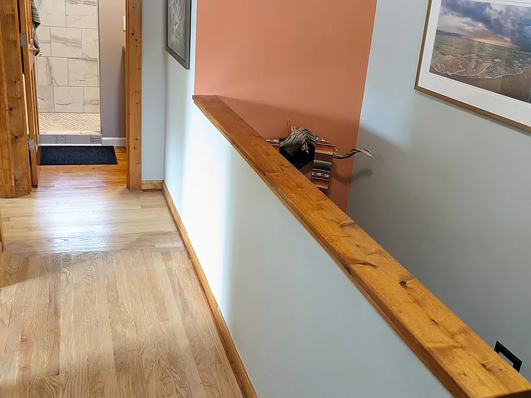 Upstairs hallway, two bedrooms off to left, bathroom straight ahead.