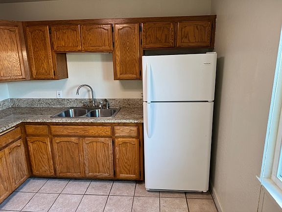 garbage disposal and fridge included kitchen