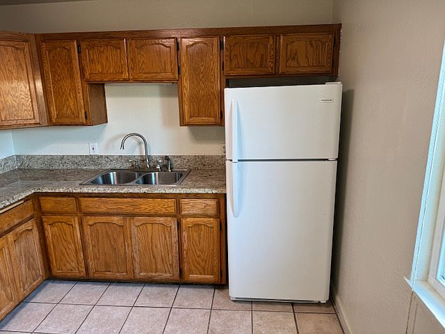 garbage disposal and fridge included kitchen