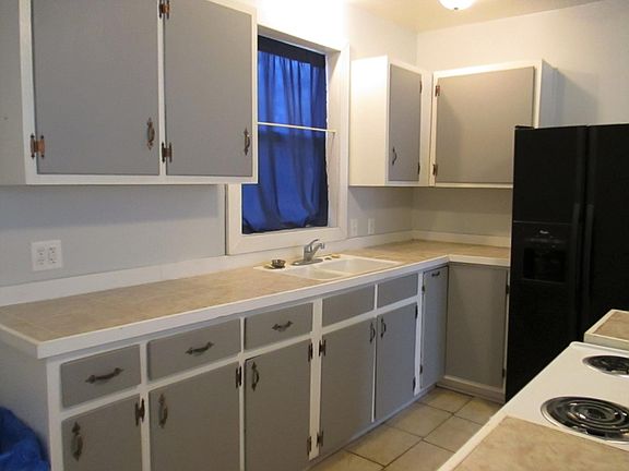 Kitchen - Side by side refrigerator, Electric stove, Double bowl sink