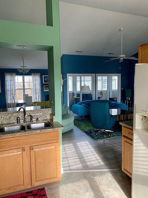 View from kitchen through living area and out to the lanai. Lanai has a bar with two chairs and two lounge chairs (not seen). Also, a window bird feeder for your enjoyment! Bird seed provided.