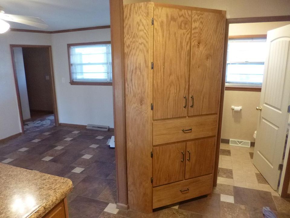 Looking into 1/2 bath/laundry room and dining room from kitc