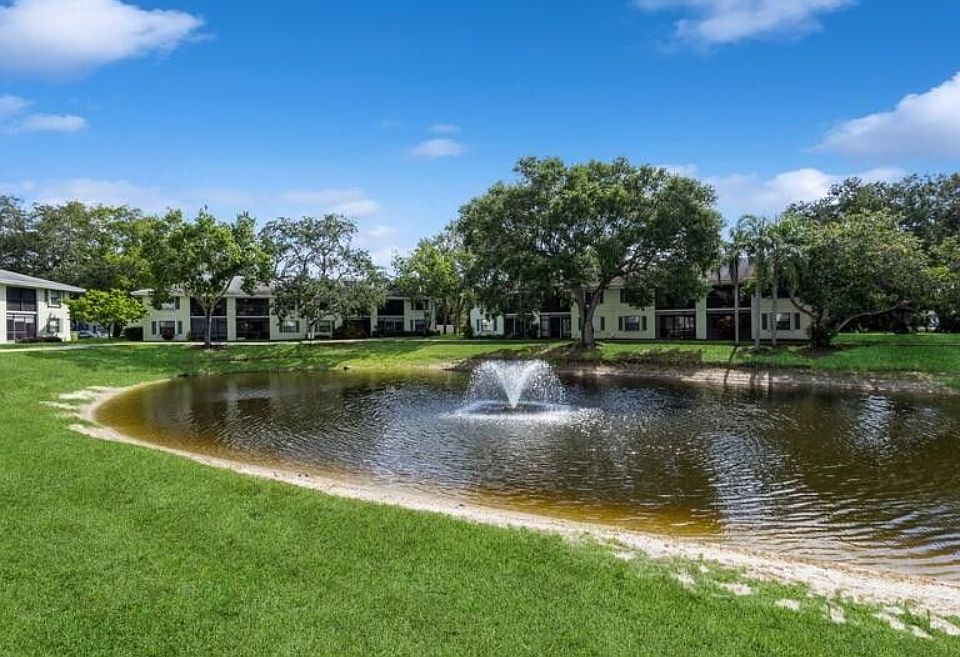 The lake is in the center of the complex with walking path around it.
