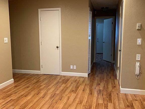 Entrance to the left, view from living room to the bedrooms.