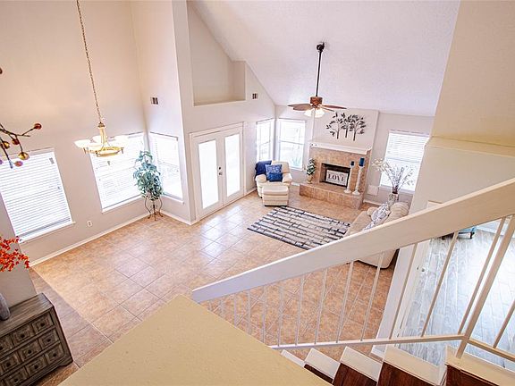 This is what greets you as you enter the front door. Super high ceilings with elegant light fixtures and ceiling fans, ton of windows and a house ready to welcome your family. It was painted all throughout, it has new blinds, no carpet anywhere, a fi
