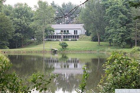 The house as seen from the other side of the 2 acre pond