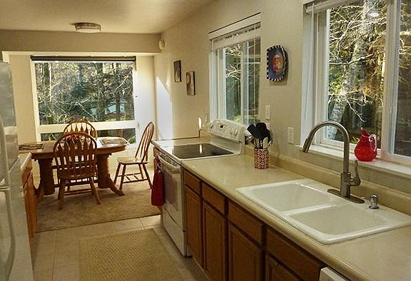 Galley Kitchen w/new stove, microwave, coffeemaker, food processor, toaster, spices, pots, pans, cutlery, dishes, etc.