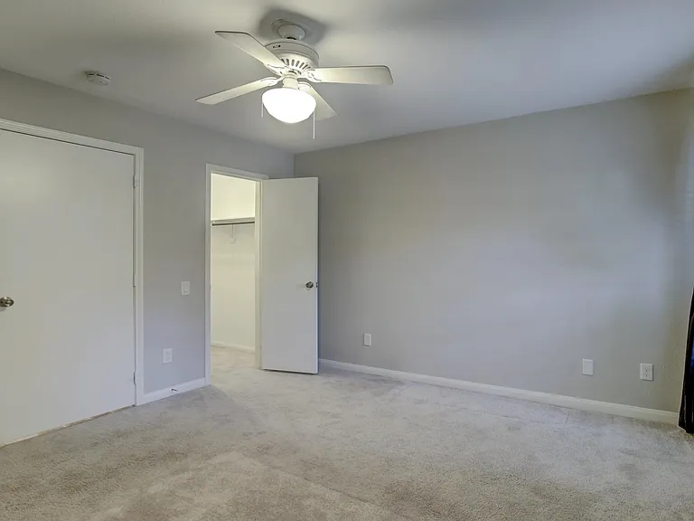 Comfortable bedroom with walk-in closet - view without furniture.