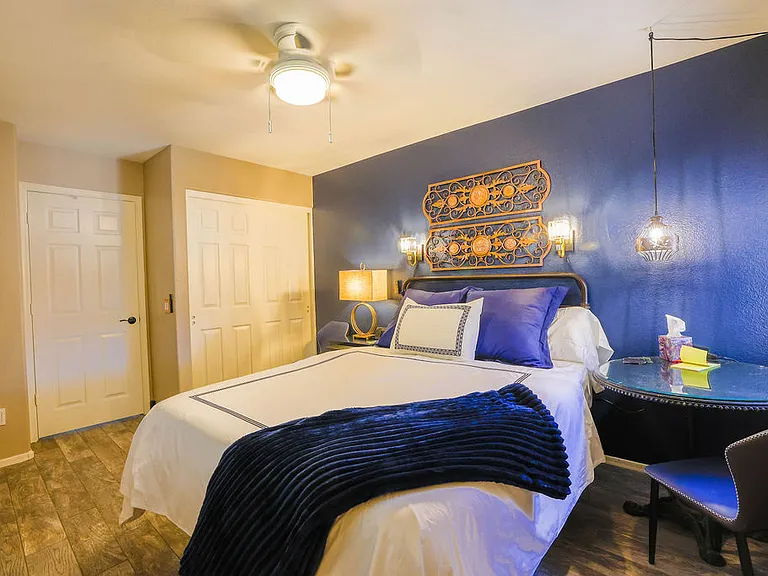 Second bedroom, queen size adjustable mattress, side table with chair, 60" TV, closet with drawers