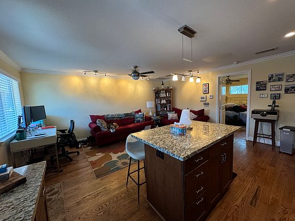 Living room and kitchen island

*This unit is currently occupied by a tenant. The existing tenant will remove all furniture and personal items at move-out. A move-in date will be coordinated with you, the new tenant.