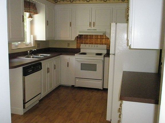 Hardwood floor in kitchen with breakfast nook.