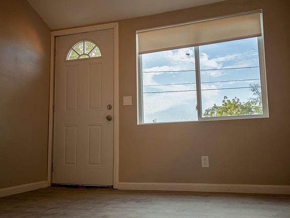 Living room. Wood floors, ceiling fans, vaulted ceiling.