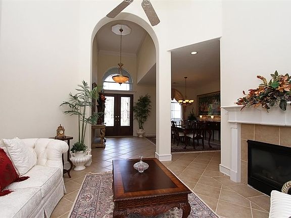 GREAT OPEN FLOOR PLAN WITH BOTH FORMAL LIVING AND DINING ROOM ADJACENT TO THE KITCHEN - This is the view looking back at the entry and dining room. The floors are large tile set on a diagonal. The formal living area is separate from the family room.