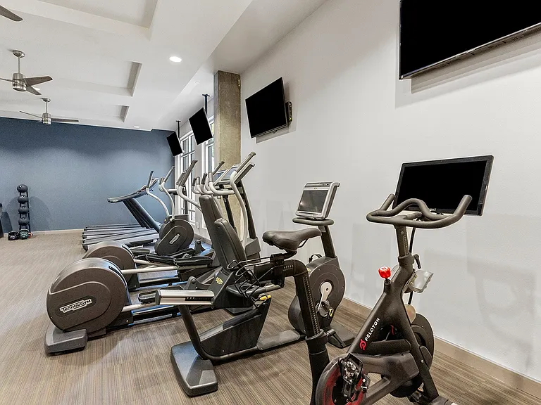 The fitness center includes Technogym equipment, cardio machines including a Peloton bike and more
