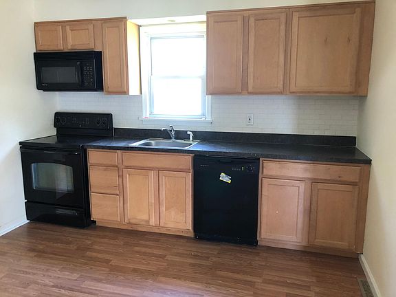 Kitchen with newer cabinets, new floor, backsplash 